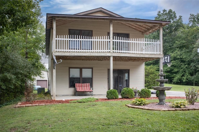 view of front of house featuring a front lawn and a balcony