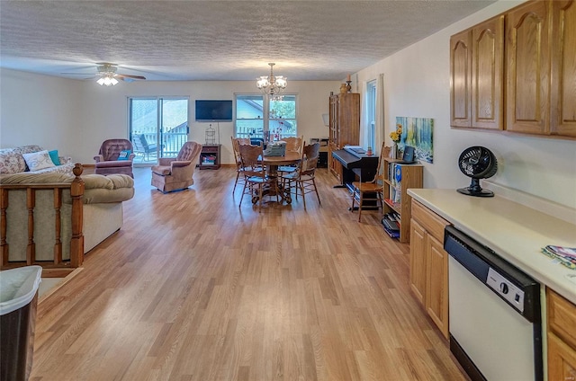 interior space with ceiling fan with notable chandelier, a textured ceiling, and light hardwood / wood-style floors