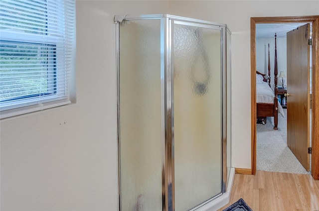 bathroom featuring hardwood / wood-style floors and an enclosed shower