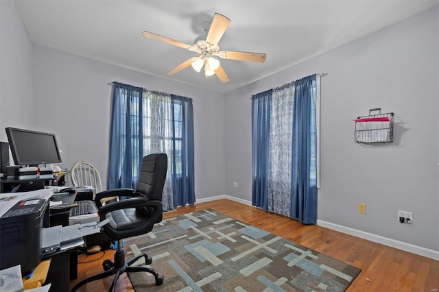 office with wood-type flooring and ceiling fan