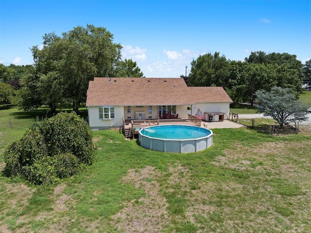 view of pool featuring a wooden deck and a lawn