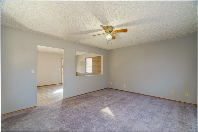 carpeted empty room with a textured ceiling and ceiling fan