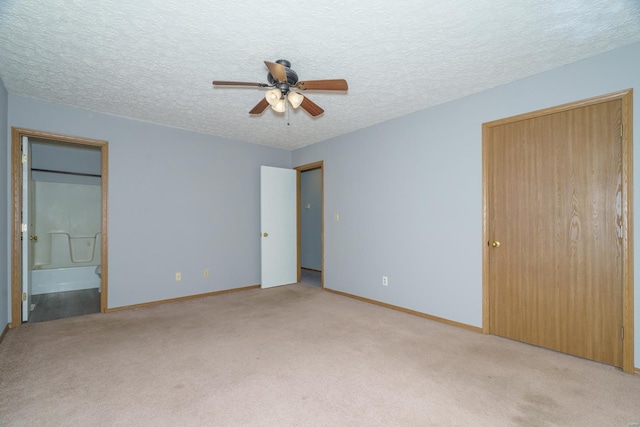 unfurnished bedroom with light carpet, a textured ceiling, ensuite bath, and ceiling fan