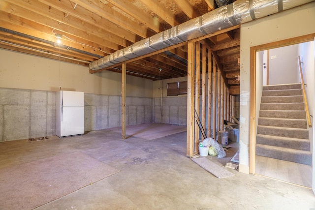 basement featuring white fridge