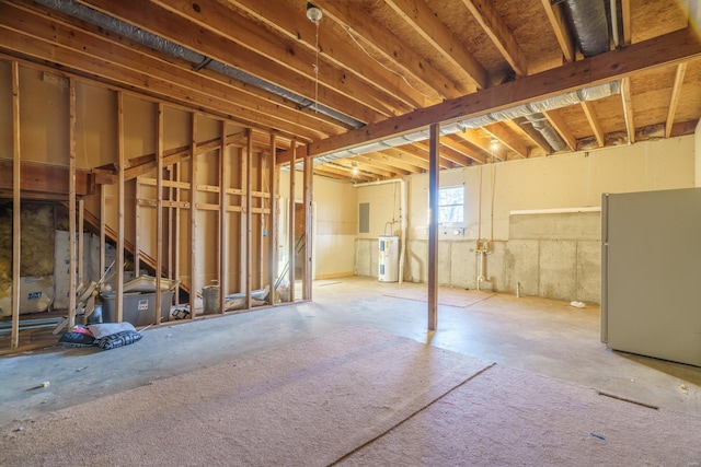 basement with refrigerator, electric panel, and water heater