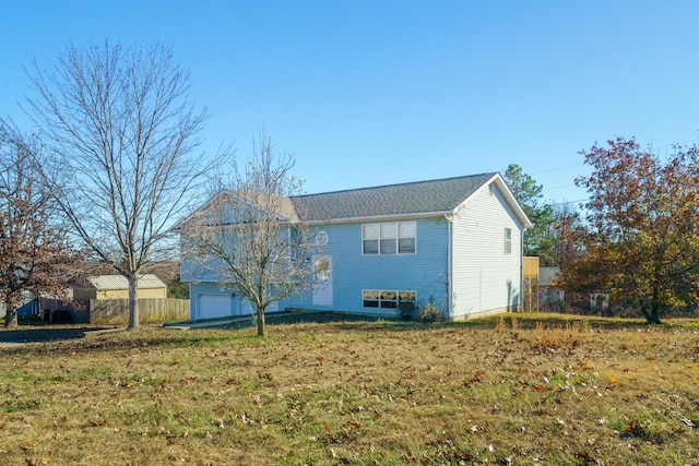 view of home's exterior featuring a lawn and a garage