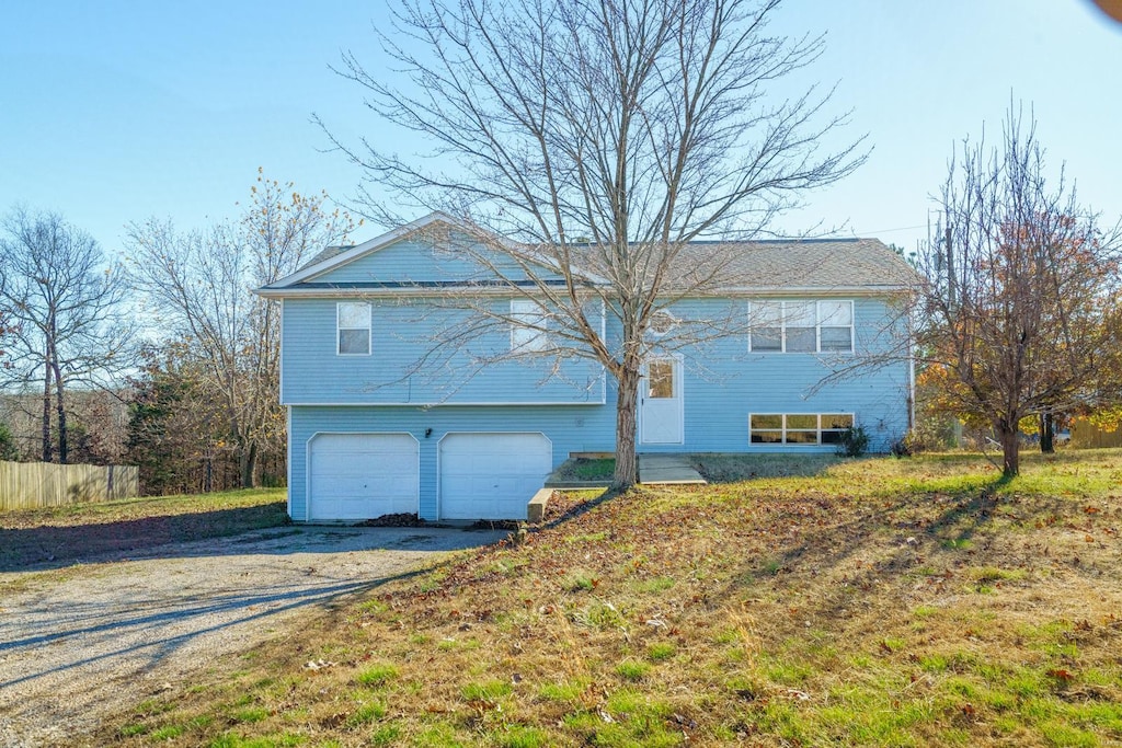 view of property exterior featuring a lawn and a garage