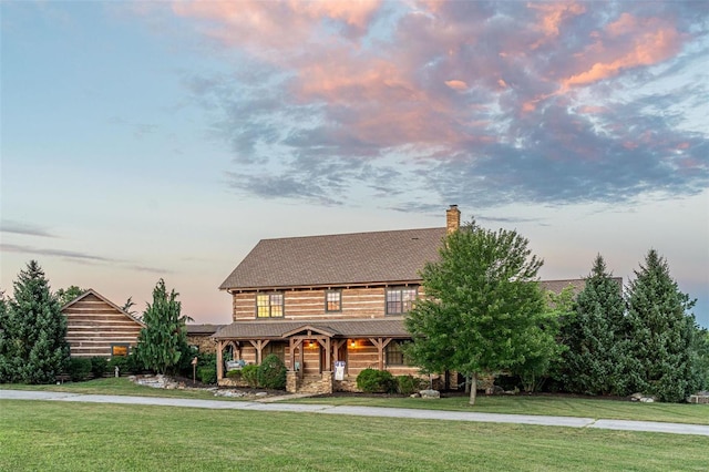 log cabin featuring a lawn