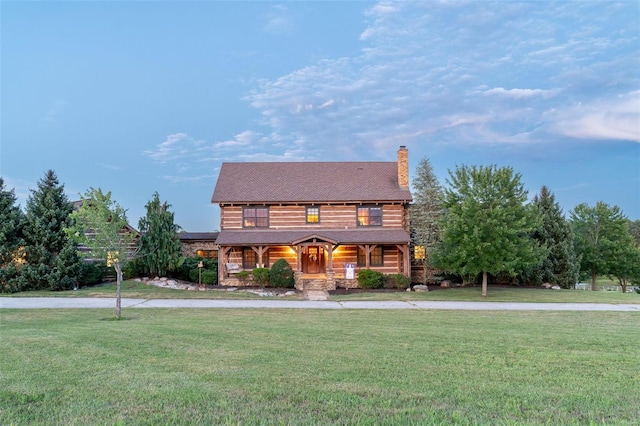 log home featuring a front yard and a porch