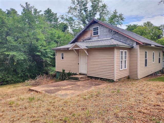 rear view of property with a yard