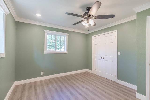 unfurnished bedroom with crown molding, a closet, ceiling fan, and light hardwood / wood-style flooring