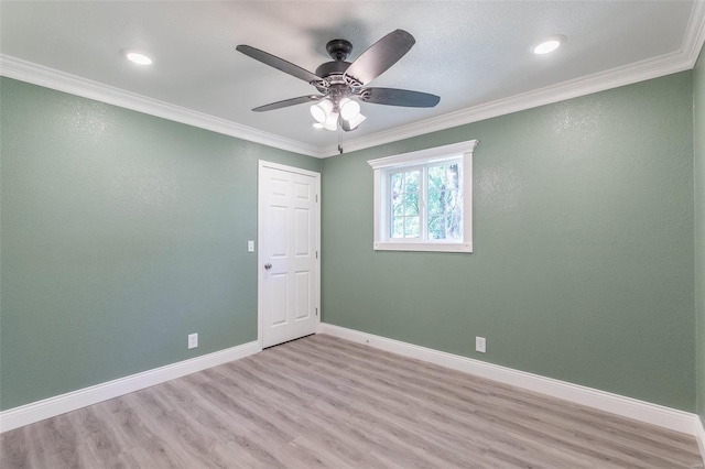 spare room with ornamental molding, ceiling fan, and light wood-type flooring