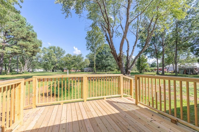 wooden deck featuring a lawn