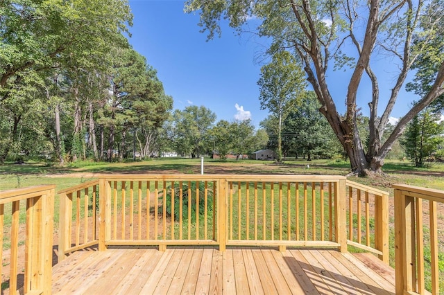 wooden terrace featuring a yard