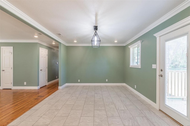 unfurnished room with ornamental molding and light wood-type flooring