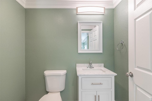 bathroom featuring ornamental molding, toilet, and vanity