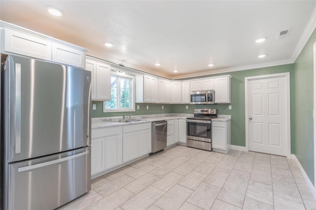 kitchen with sink, white cabinetry, crown molding, stainless steel appliances, and light stone countertops