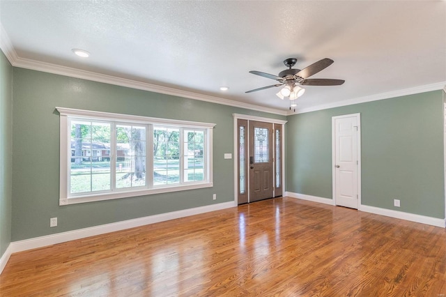 entrance foyer featuring crown molding, ceiling fan, and wood-type flooring