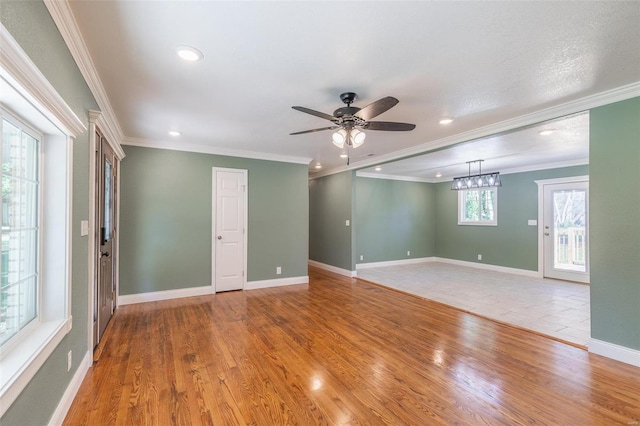 unfurnished room with crown molding, ceiling fan, and light hardwood / wood-style flooring