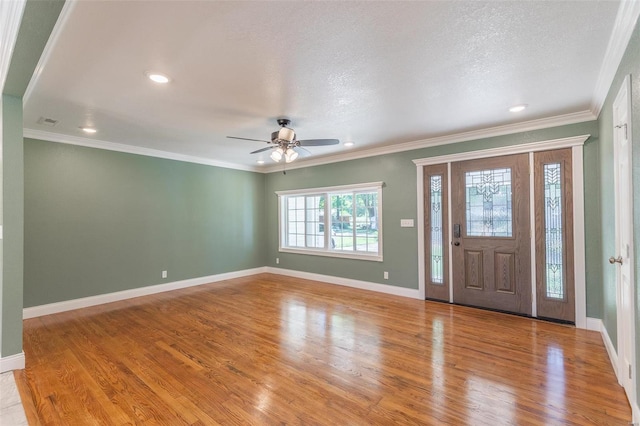 entrance foyer with crown molding, a textured ceiling, ceiling fan, and light hardwood / wood-style floors