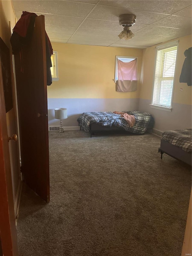 unfurnished bedroom featuring dark colored carpet and ceiling fan