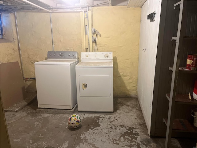 washroom with washing machine and clothes dryer