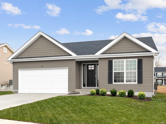 view of front of property with a garage and a front lawn