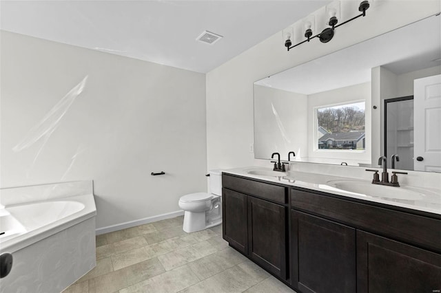 bathroom with double vanity, a sink, toilet, and a shower stall