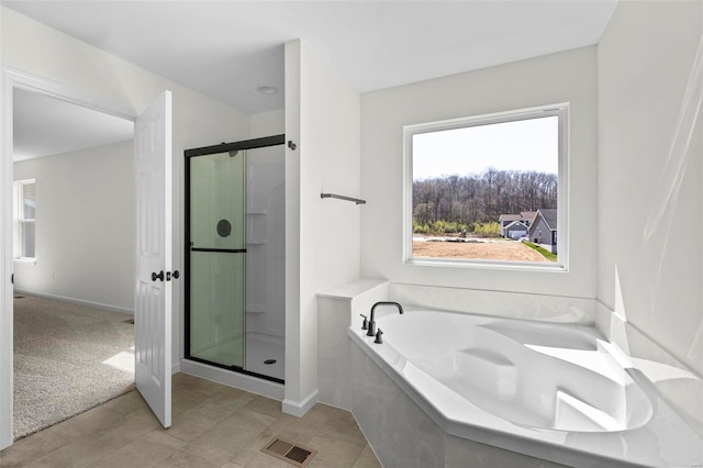 full bath with a bath, a stall shower, and visible vents