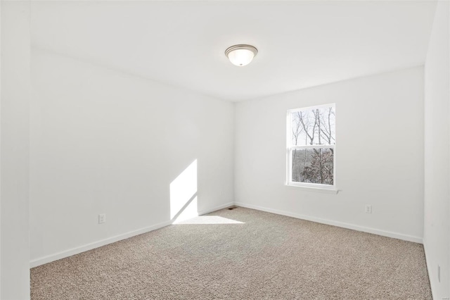 spare room featuring light colored carpet