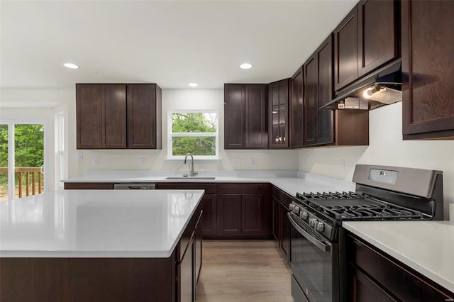 kitchen with black range with gas stovetop, dark brown cabinetry, sink, dishwasher, and light hardwood / wood-style floors