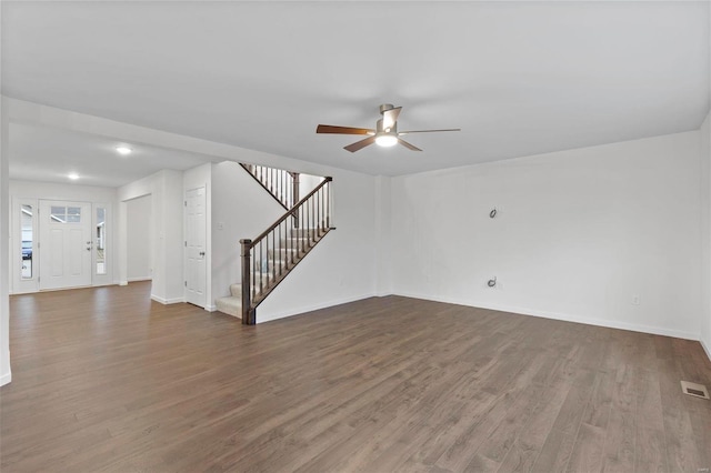 unfurnished living room with ceiling fan and dark wood-type flooring