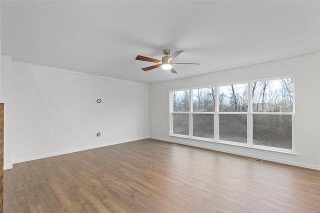 unfurnished room featuring hardwood / wood-style floors, plenty of natural light, and ceiling fan