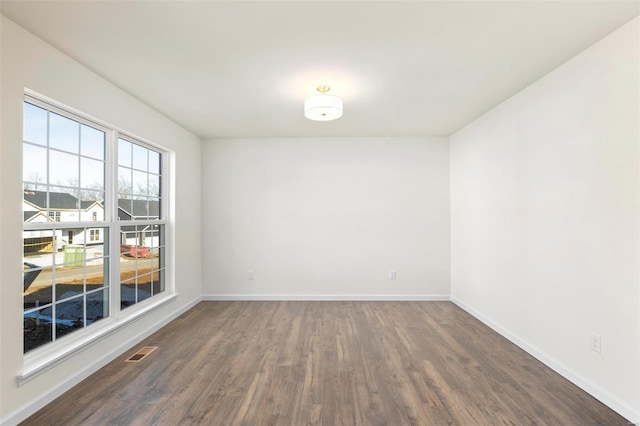 unfurnished room with dark hardwood / wood-style floors