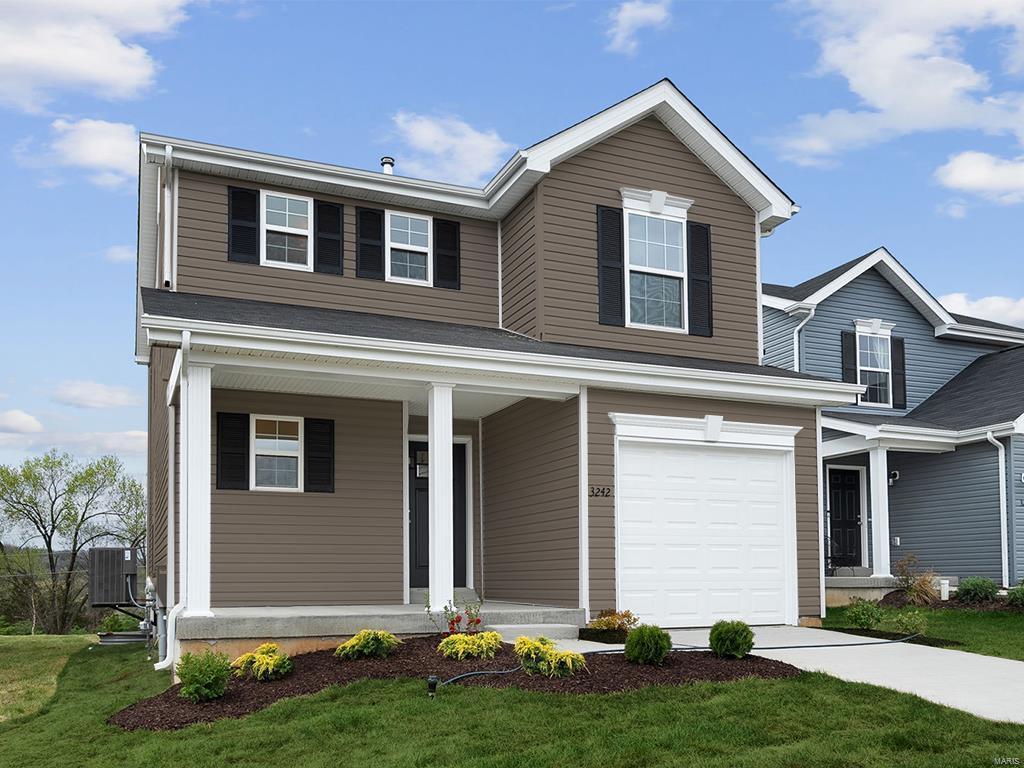 view of front facade featuring central AC unit, a garage, and a front lawn