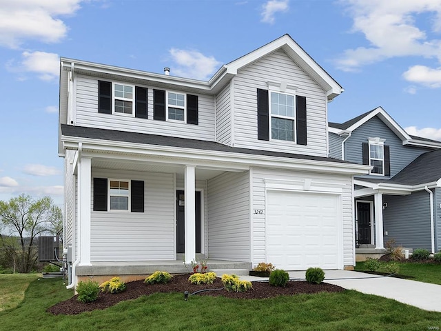 view of front property with a garage, cooling unit, and a front lawn