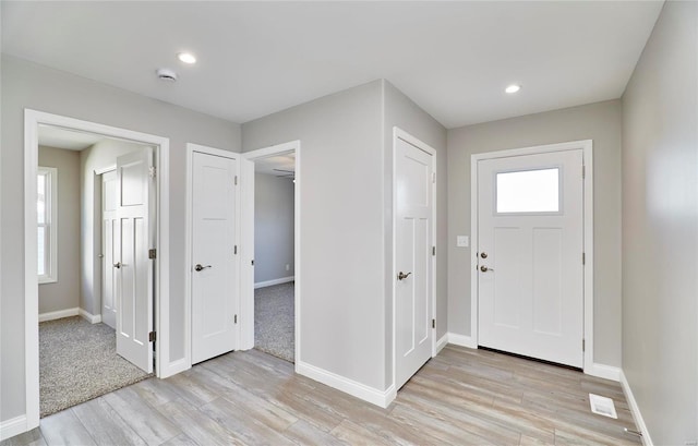 entryway with a healthy amount of sunlight and light hardwood / wood-style flooring