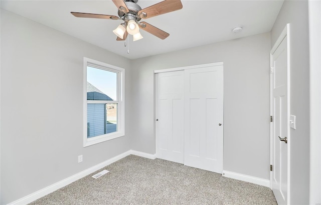 unfurnished bedroom featuring ceiling fan, carpet flooring, and a closet