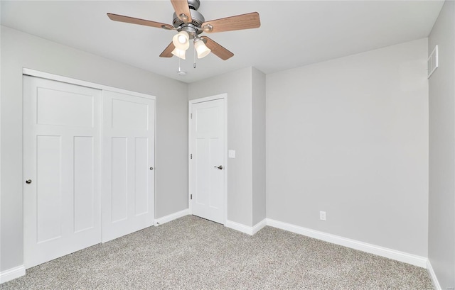 unfurnished bedroom with ceiling fan, a closet, and light carpet