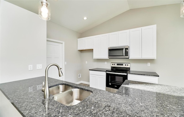 kitchen with vaulted ceiling, appliances with stainless steel finishes, sink, white cabinets, and dark stone counters