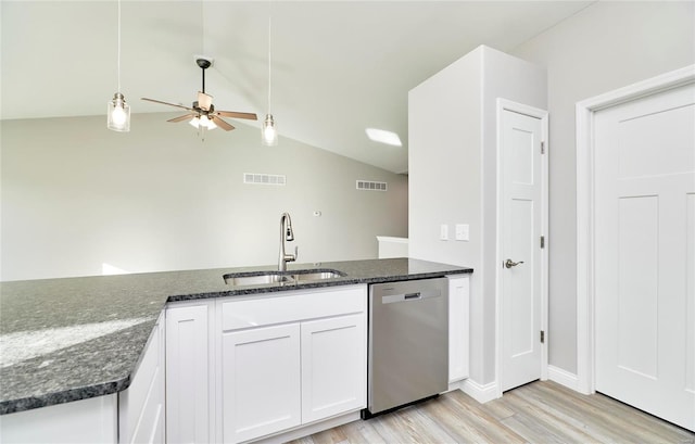 kitchen featuring dishwasher, sink, dark stone countertops, and white cabinets