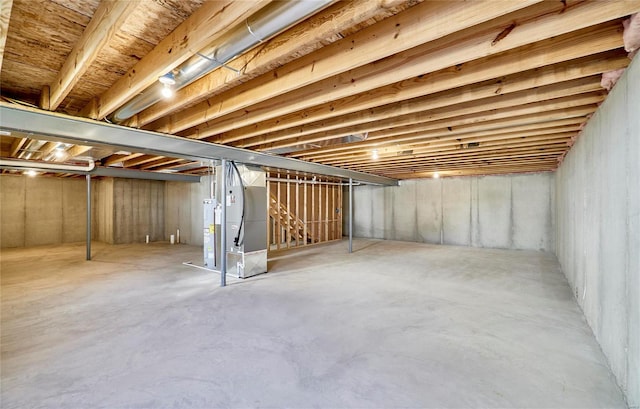 basement with electric water heater and heating unit