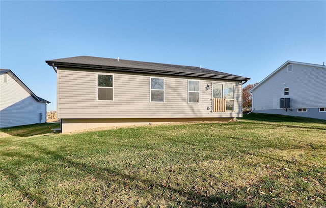 rear view of property featuring a yard