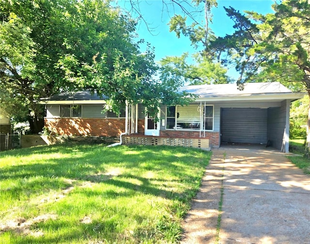 single story home featuring a carport, a garage, and a front lawn