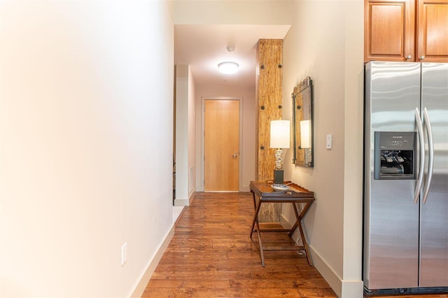 corridor with hardwood / wood-style floors