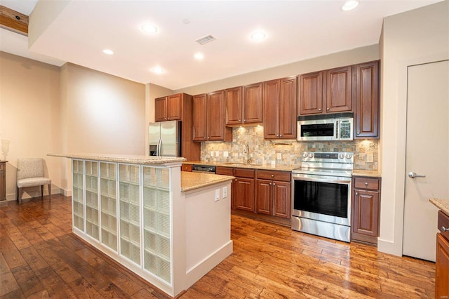 kitchen featuring decorative backsplash, stainless steel appliances, dark hardwood / wood-style flooring, and sink