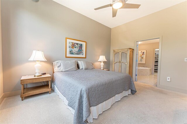 carpeted bedroom with ensuite bathroom and ceiling fan