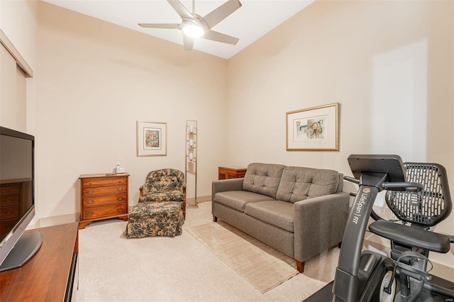 carpeted living room with ceiling fan and high vaulted ceiling