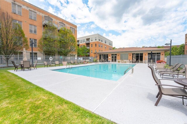 view of pool with a yard and a patio area