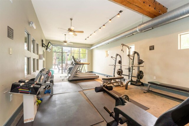 interior space featuring rail lighting and ceiling fan